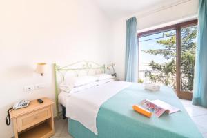 a bedroom with a large bed and a window at Hotel Europa in Ischia