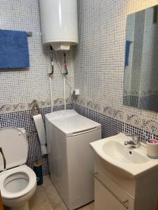 a bathroom with a toilet and a sink at sa caleta blava in Cala en Blanes