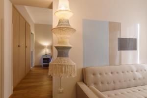 a large chandelier in a living room with a couch at Aurora Boutique Hotel & Private SPA - Etruria Collection in Spoleto