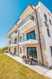 a building with benches in front of it at Golden Rose Suit pension in Kaş