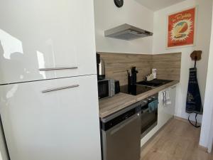 a kitchen with a refrigerator and a stove and a sink at L'Augustine - Spa privé & Vue Montagne in Saint Avre la Chambre +25 photos