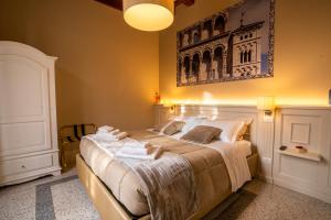 a bedroom with a large bed with towels on it at Noble Floor - Luxury Apartments in Lucca