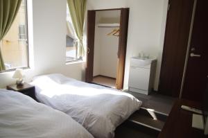 Rúm í herbergi á Suminoyu Hotel