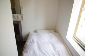 Rúm í herbergi á Suminoyu Hotel