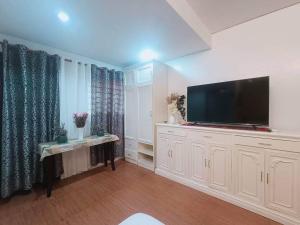 sala de estar amplia con TV de pantalla plana. en 1 - Affordable Family Place to Stay In Cabanatuan, en Cabanatúan