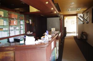 a restaurant with a long counter in a room at Suminoyu Hotel in Nagoya