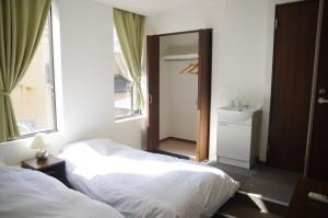 Rúm í herbergi á Suminoyu Hotel