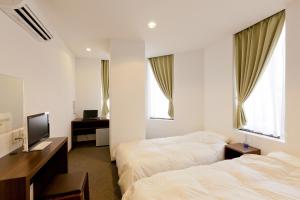 Rúm í herbergi á Suminoyu Hotel