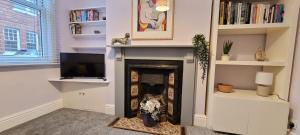 a living room with a fireplace and a tv at Hartoft St - 2 bed near river in York