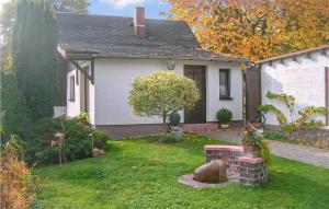 a house with a yard with a brick fire place at Gorgeous Home In Schlema Ot Wildbach With Kitchen in Schlema