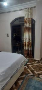 a bedroom with a bed and a room with a mirror at apartment for rent in Luxor