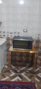 a microwave sitting on a table in a room at apartment for rent in Luxor