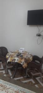 a table with two chairs and a table with a patterned at apartment for rent in Luxor