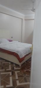 a bedroom with a bed in a room with a floor at apartment for rent in Luxor