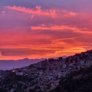 a city on a hill with a sunset at Panorama in Arachova