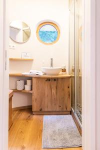 a bathroom with a sink and a shower at WOHNWAGON Tiny Houses I in Gutenstein