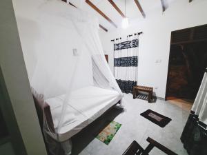 Ένα ή περισσότερα κρεβάτια σε δωμάτιο στο Guruge guest house