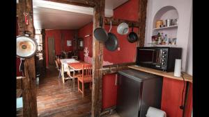 a kitchen with red walls and a table with chairs at Cathédrale spacieux appartement in Strasbourg