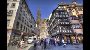 a group of people on a city street with buildings at Cathédrale spacieux appartement in Strasbourg