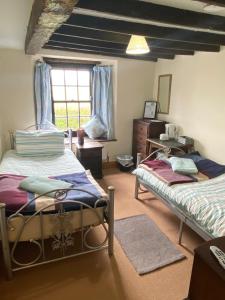 a bedroom with two beds and a window at The crown inn Longtown in Hereford