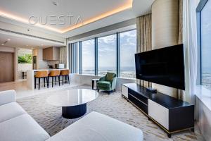 a living room with a couch and a tv at The Palm Tower, Nakheel Mall, Palm Jumeirah in Dubai
