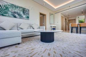 a living room with a couch and a table at The Palm Tower, Nakheel Mall, Palm Jumeirah in Dubai