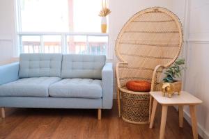 a living room with a blue couch and a large mirror at AUBERGE DU DIMANCHE - Hotel - Fjord-du-Saguenay - l'Anse-Saint-Jean - Riviere-Eternite in Riviere Eternite