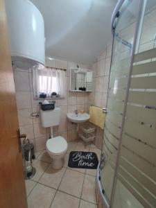 a small bathroom with a toilet and a sink at Apartment Selak in Šibenik +19 photos