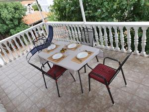 a white table and chairs on a patio at Apartment Selak in Šibenik