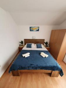 a bedroom with a bed with two towels on it at Apartment Selak in Šibenik