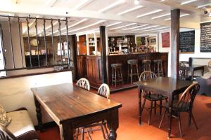 un ristorante con due tavoli e sedie e un bar di The crown inn Longtown a Hereford