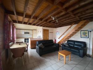 a living room with a couch and a table at Aux 4 chalets in Bouillon