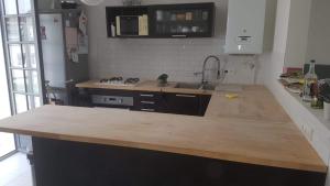 a kitchen with a wooden counter top in a room at Chez Aurélie in Brest