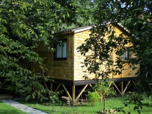 a small wooden cabin in the middle of trees at CHALET Chataigne ETAPEBOISEE in Fumay