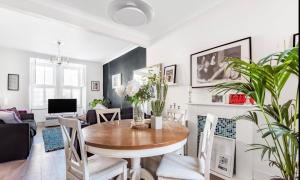 a dining room and living room with a table and chairs at Inviting 3-Bed House in Beckenham in Beckenham