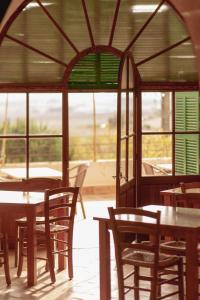 a restaurant with tables and chairs and windows at Agroturismo Son Sant Andreu in Petra