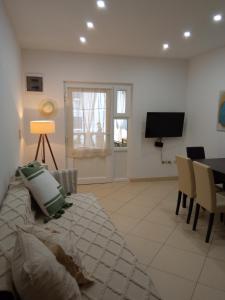 a living room with a couch and a table and a television at Apartments Tomić in Vodice