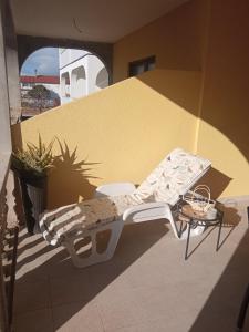 a bed sitting on the side of a building at Apartments Tomić in Vodice