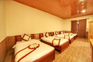 a room with four beds in a row with at KB VILLA in Da Lat