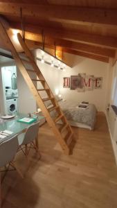 a loft bedroom with a bed and a staircase at La Rovettina in Verolanuova