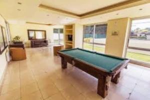 a large room with a pool table in it at Apto con piscinas, servicios, cochera, wifi in Punta del Este