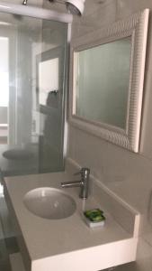 a bathroom with a sink and a mirror at Lindo Apartamento Copacabana in Rio de Janeiro