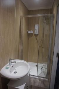 a bathroom with a shower and a sink and a shower at No1 Dalbeg, a Hebridean Escape and your Adventure. 
