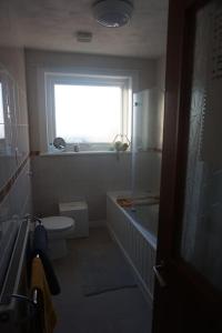 a bathroom with a window and a sink and a toilet at No1 Dalbeg, a Hebridean Escape and your Adventure. 