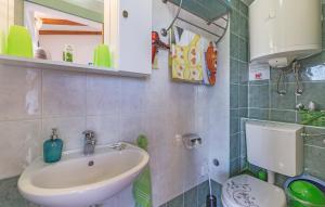 a bathroom with a sink and a toilet at Apartman Karo in Vrsar +17 photos