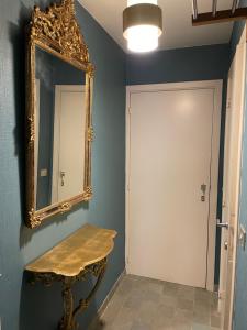 a mirror on a wall next to a door at La Corneille en Mer in Ostend