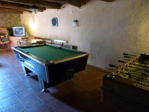 a room with a pool table and several tables at Casa Mur A in Foradada de Toscar