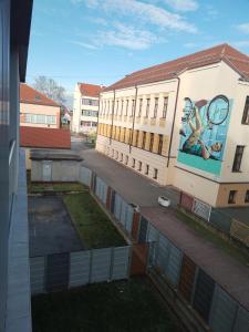 a building with a mural on the side of it at Studio apartman Implex in Đakovo