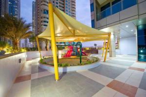 a playground in the middle of a building at 1 Bed Apartment with Sea View, Pool, Gym & Free Parking in Dubai Marina in Dubai