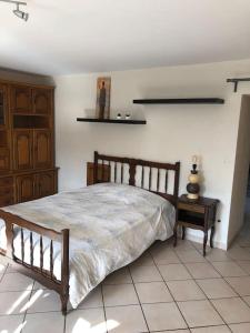 a bedroom with a wooden bed and a table at Oncle xa 